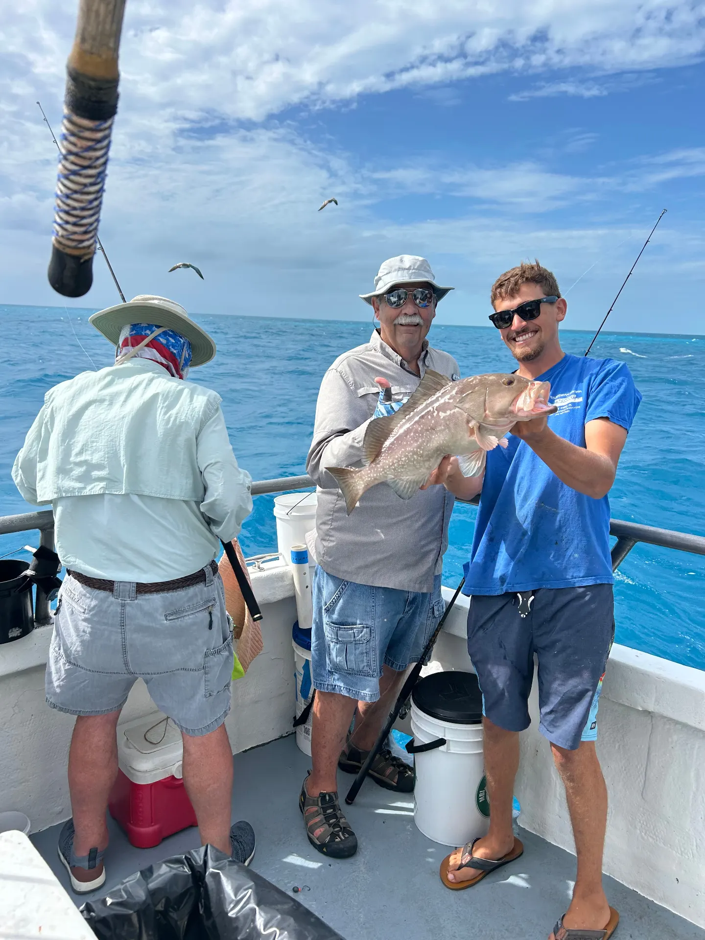 Father and son holding grouper on Gulfstream fishing charter Key West
