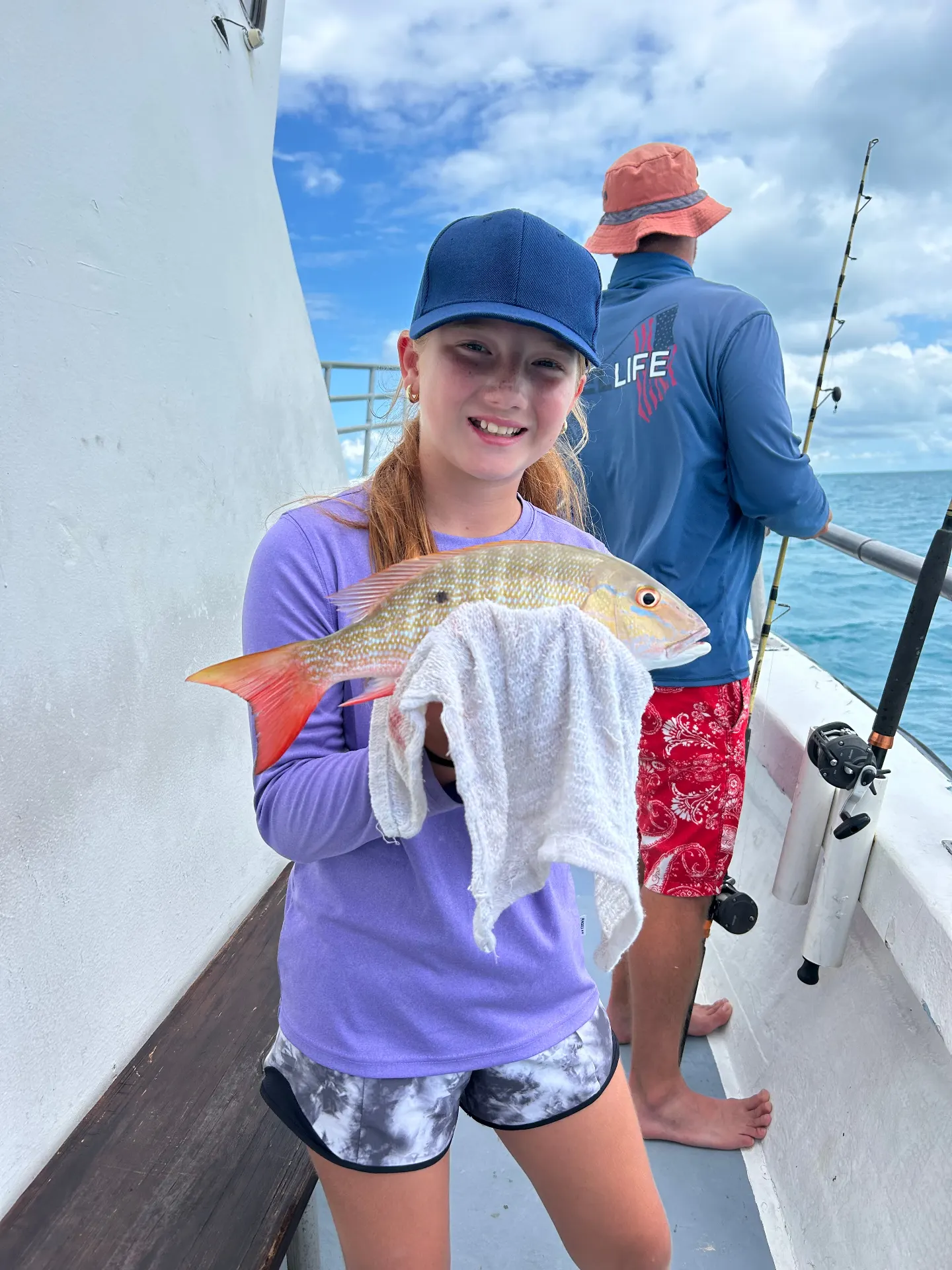 Young girl proudly holding yellowtail snapper family fishing trip Key West Gulfstream