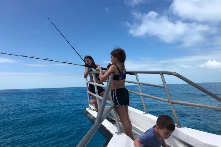 a man riding on the back of a boat in a body of water