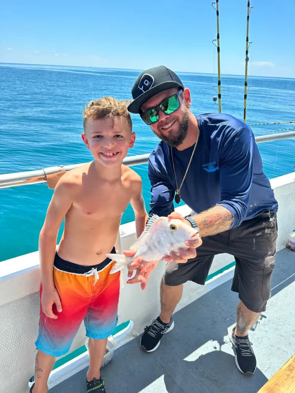 a man standing next to a body of water