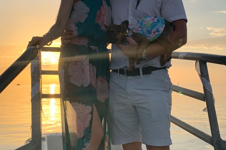 a man and a woman standing next to a body of water
