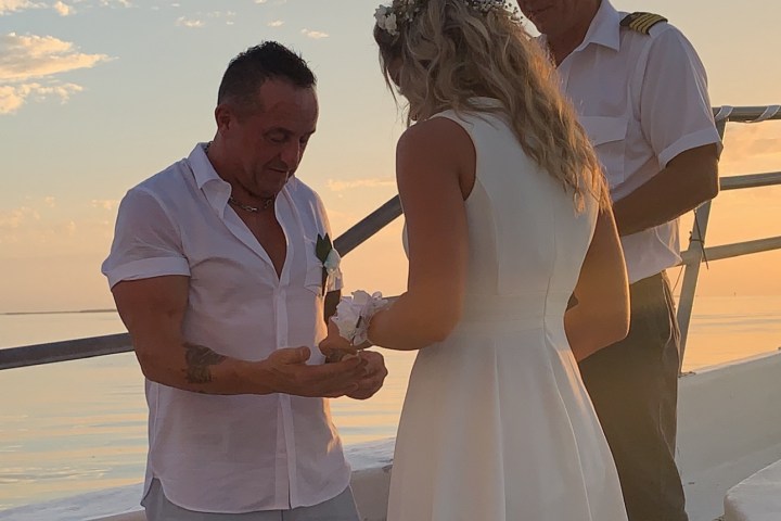 a man and a woman standing next to a body of water