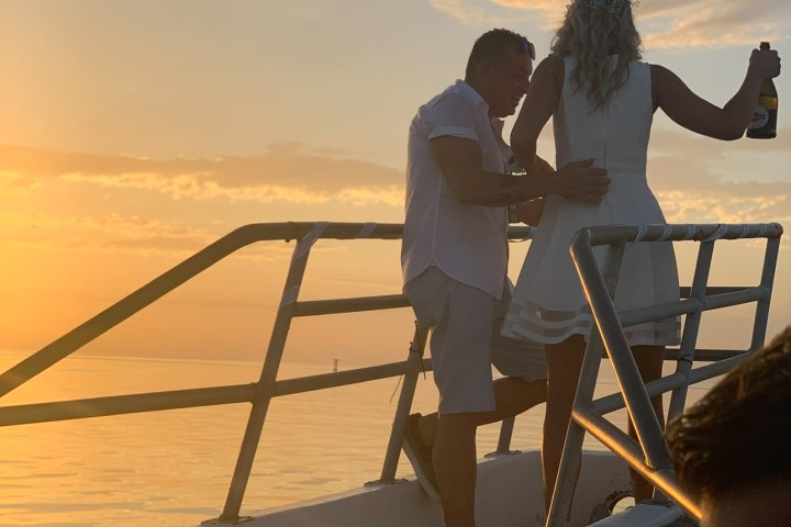a couple of people that are standing in front of a body of water